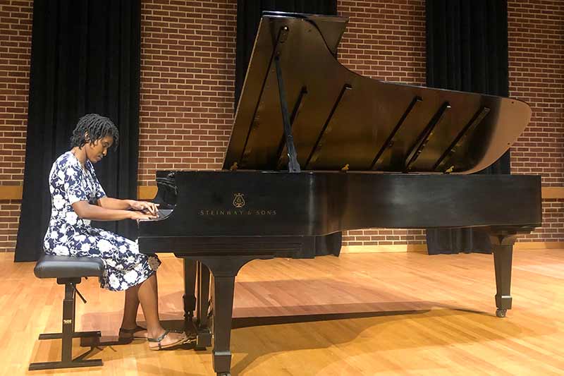 Aliyana playing piano.
