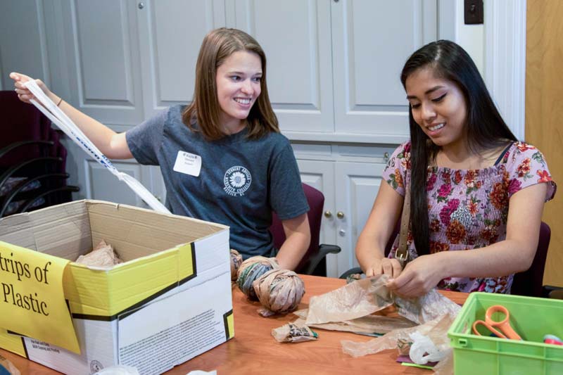 Meredith Students removing and recycling plastic from various products.