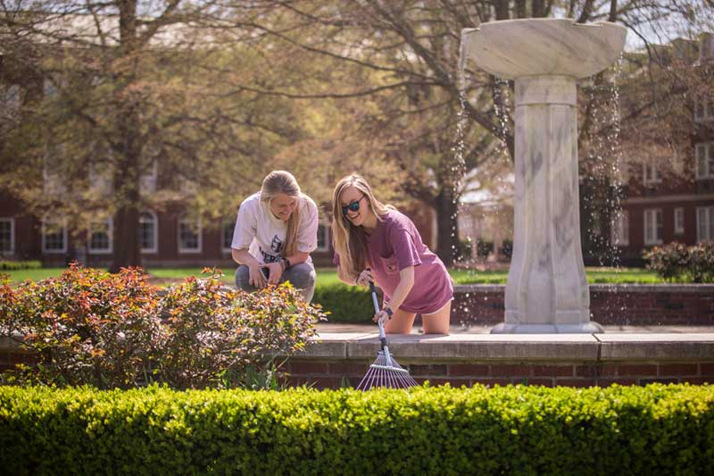 Students Looking for Crook in Quad Fountain