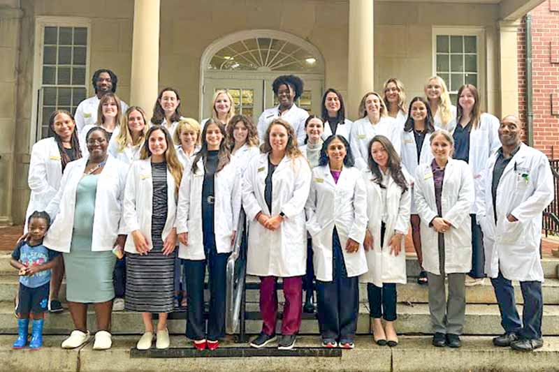 2024 dietetic internship class on the steps of Martin hall - one graduate has her child with her.
