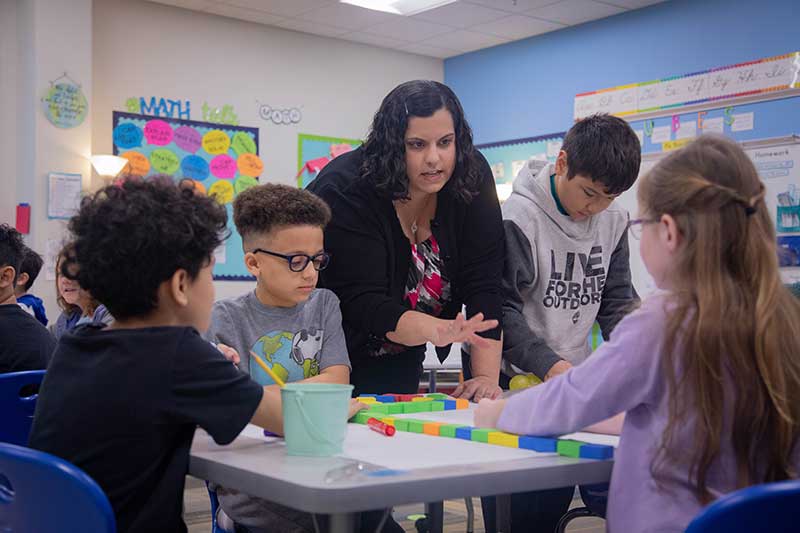 Diana Burrafato working with 3rd grade students.