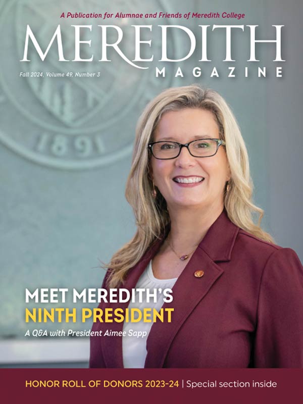 Dr. Sapp in front of the Meredith seal on the cover of the Fall 2024 meredith magazine.
