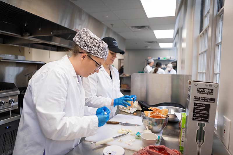 Graduate nutrition students preparing food in the new nutrition lab.