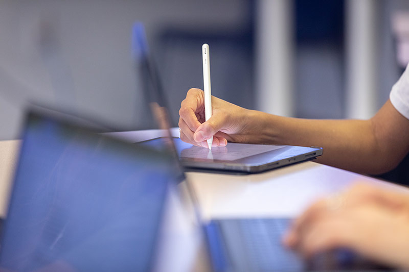 Hands working at a computer.
