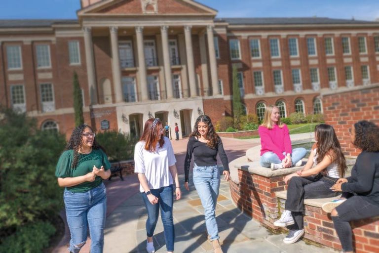Group of students socializing outside Johnson Hall.