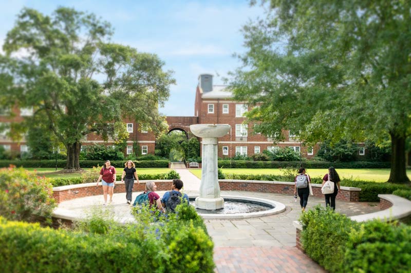 Students walking and lounging around Heck Fountain.