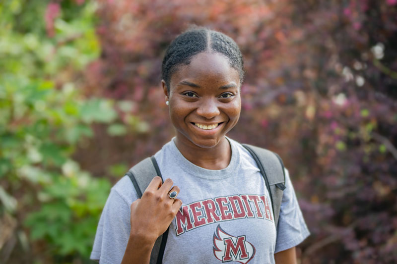 A student smiling to the camera.