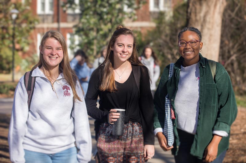Students walking on campus on the first day of class in spring.
