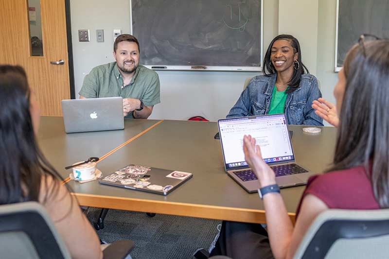 Students listen attentively to a professor during a study group for Biomedical Sciences.