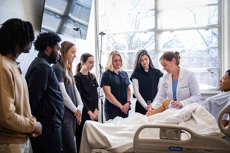 Students look on during a Master of Science in Nutrition sim lab experience.
