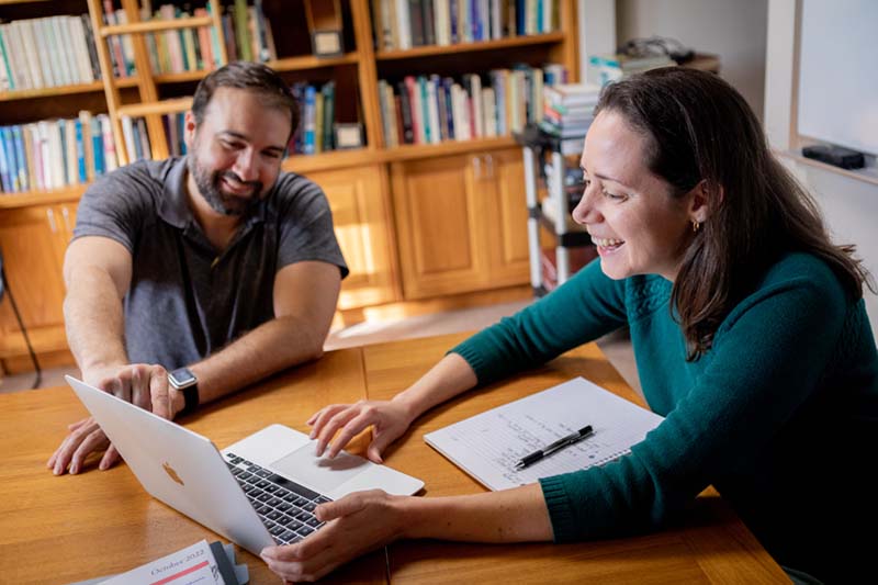 Two people studying at the library