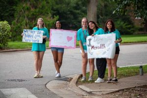 Students holding welcome signs on Move-In Day