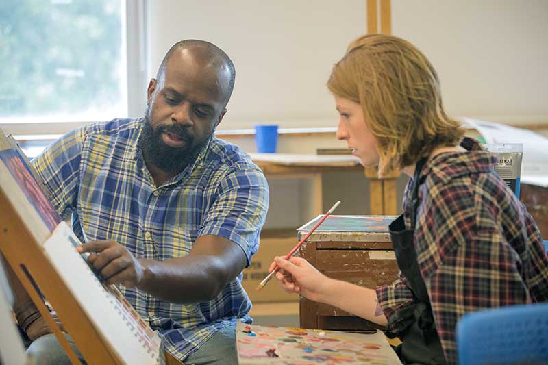 Professor Cameron Johnson and Student Discussing Painting.