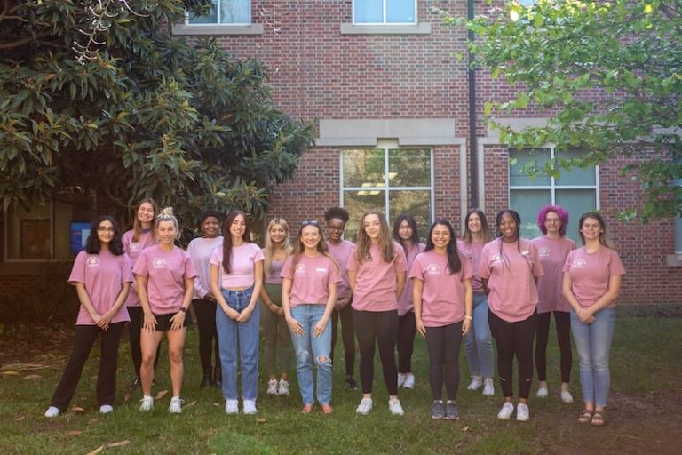 The PEARLs members wearing club shirts.