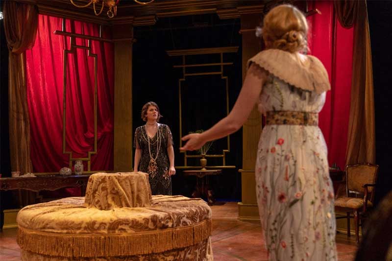 Two actresses on stage during a production.