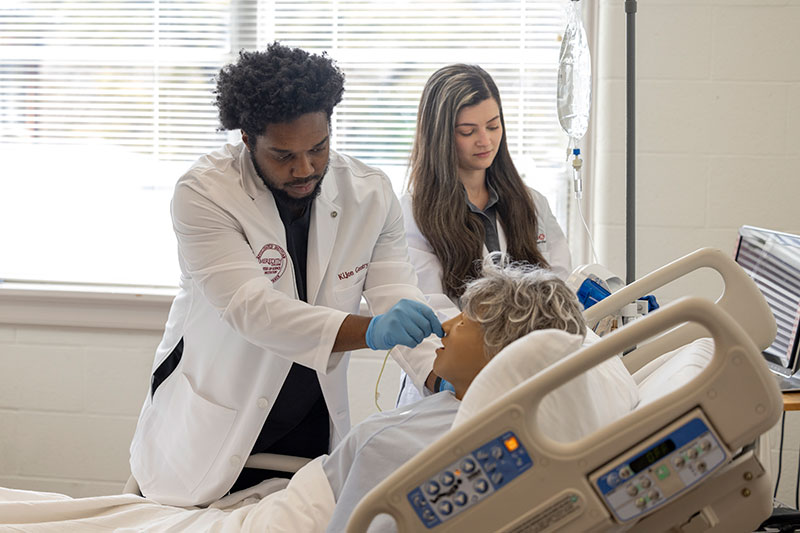 Two MSN Students Working on Dummy in Lab