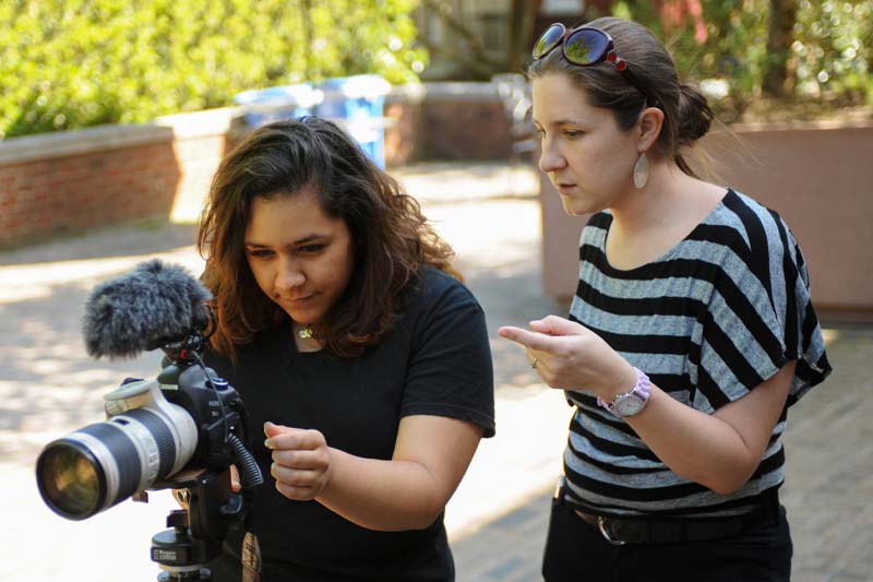 Female intern with supervisor looking at camera